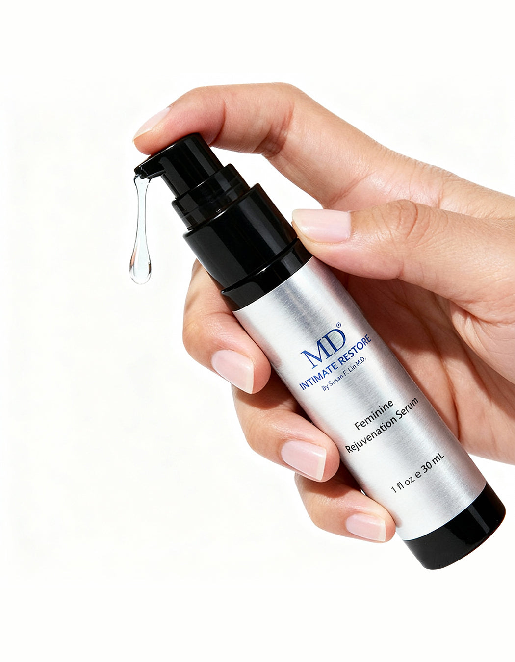 A close-up lifestyle photo of a hand pumping a clear drop of MD Intimate Restore serum, demonstrating the lightweight, fast-absorbing texture for anti-aging care of sensitive intimate skin.